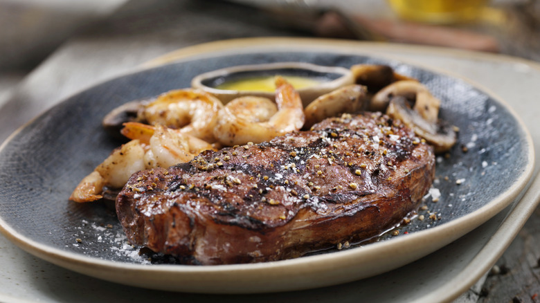 grilled top sirloin plated with shrimp and mushrooms