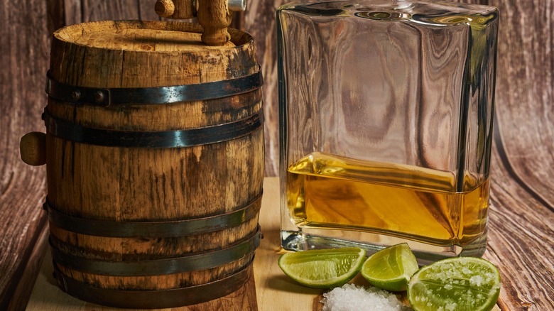 Tequila next to barrel.