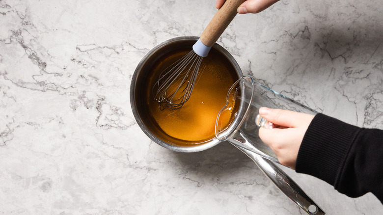 Whisking syrup in saucepan