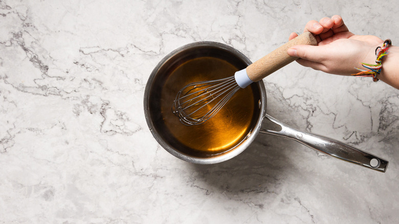 Whisking syrup in saucepan