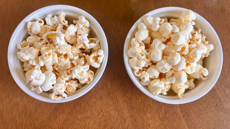 Two small bowls of popcorn on wooden table