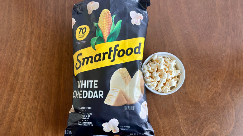 Bag of Smartfood popcorn next to small bowl of popcorn