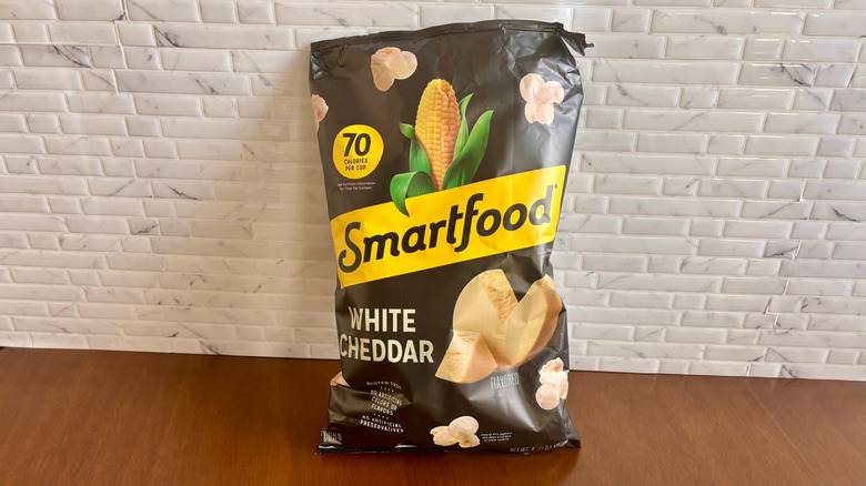 Bag of Smartfood popcorn in front of white tiled wall