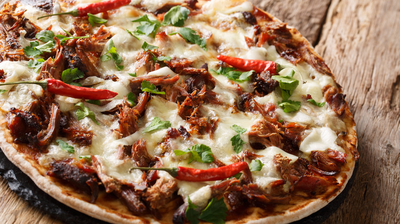 Pork, herbs, and peppers on pizza