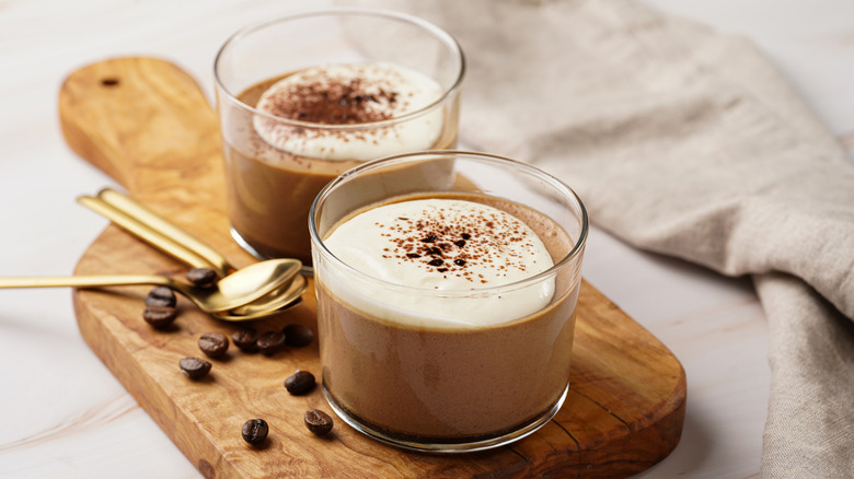 Coffee mousses topped with cream in cups