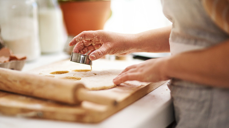 baker cutting circles out of dough