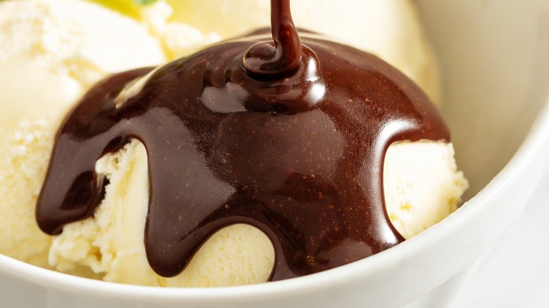 Hot fudge being poured on ice cream