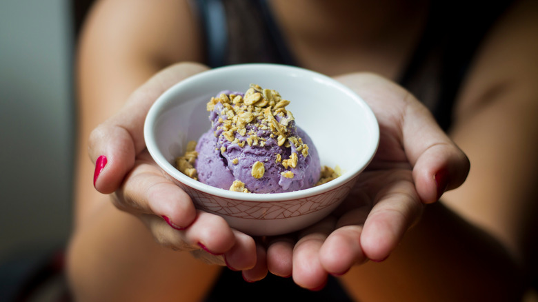 Hands holding bowl of ice cream