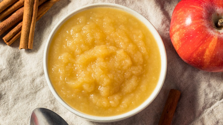 Bowl of applesauce with cinnamon sticks