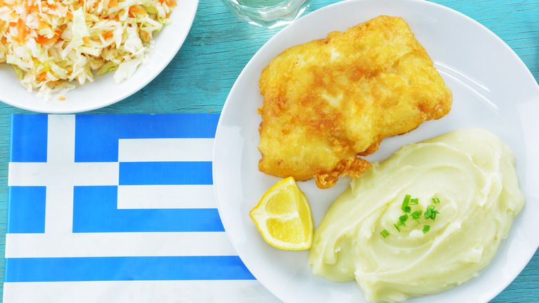 Skordalia on a plate with fish on a Greek flag