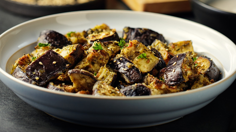 cubes of marinated roasted eggplant in a white serving dish