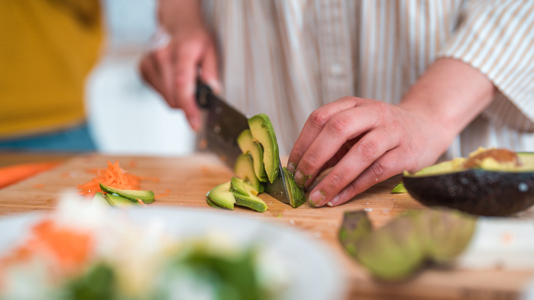 woman slicing avocado