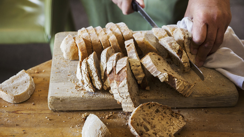 man slicing bread