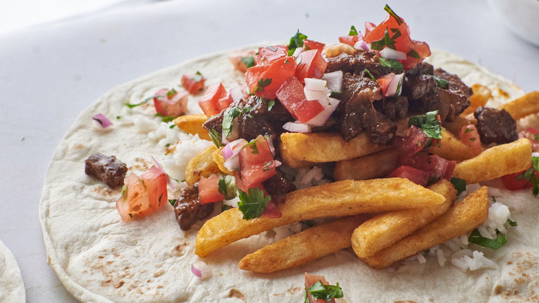 Fries and other fillings atop a tortilla 