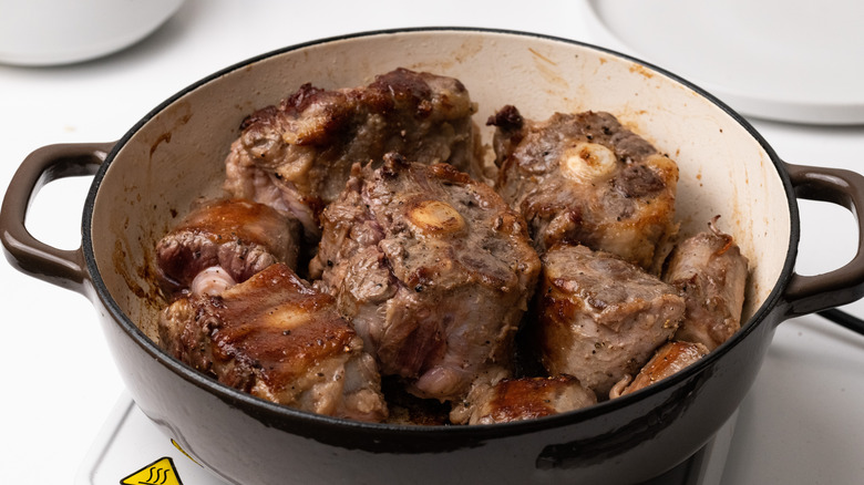 oxtail browning in a pan 