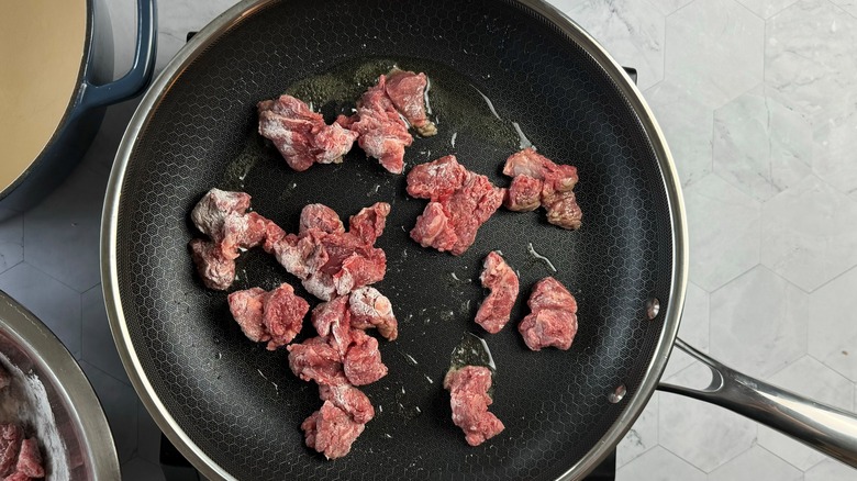 meat chunks in frying pan