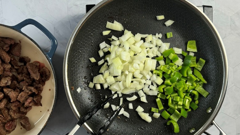 onions and peppers in pan