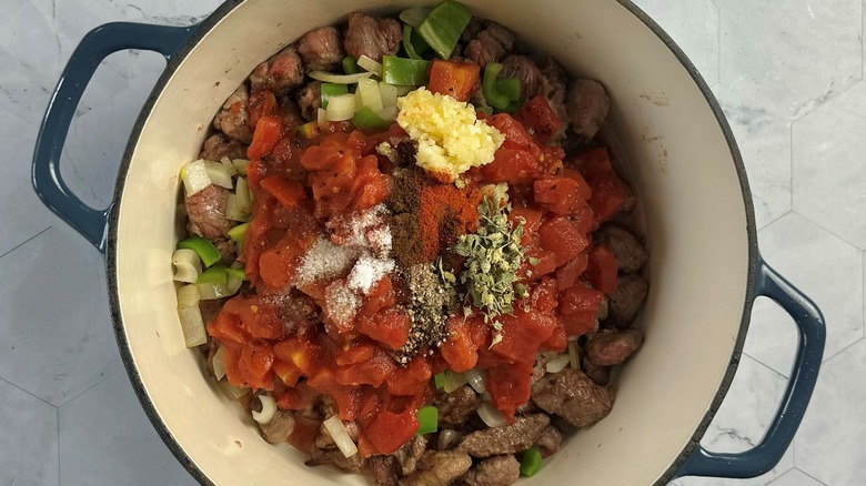 tomatoes and meat in pot