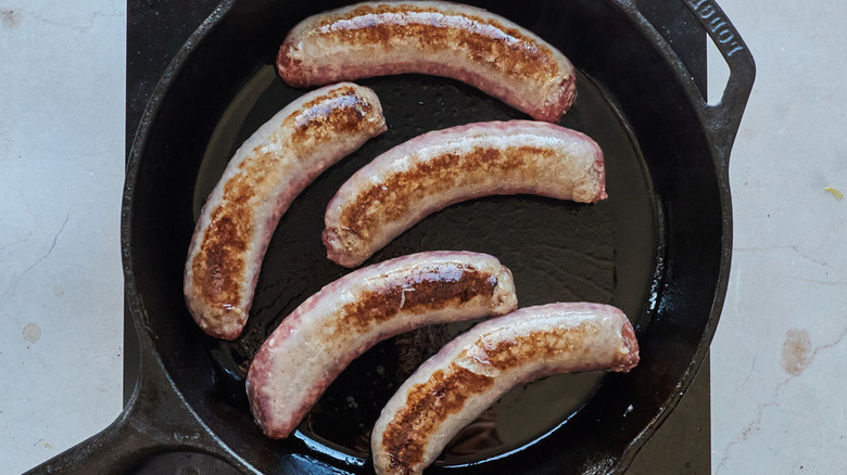 brats searing in skillet