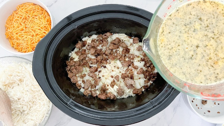 assembling breakfast casserole in slow cooker