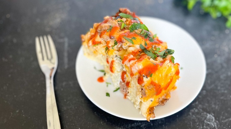 breakfast casserole on plate with sriracha