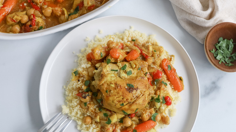 Chicken and artichoke tagine on a plate with couscous