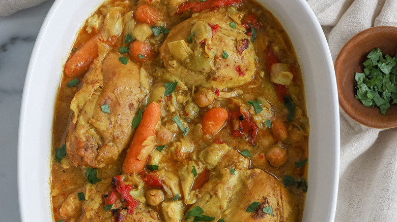 cooked chicken and artichoke tagine in a casserole dish