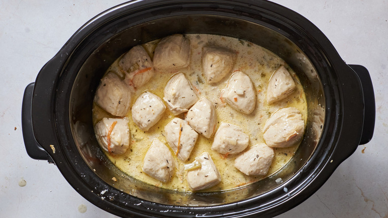 dumplings in creamy broth in slow cooker