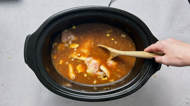 stirring ingredients in slow cooker