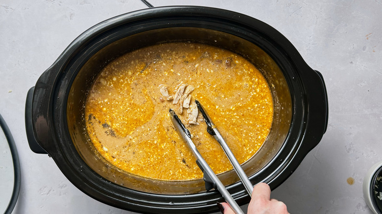 adding chicken to slow cooker