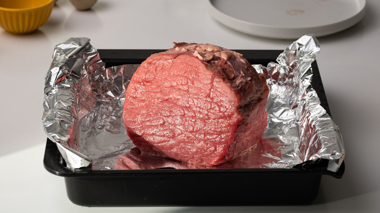 raw beef on roasting tray