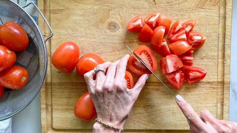 slicing tomatoes on cutting board