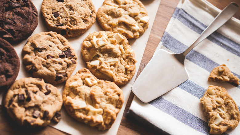 Variety of cookies on counter with spatula 