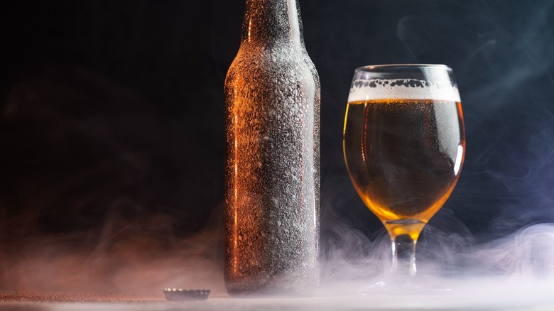 glass of beer surrounded by smoke