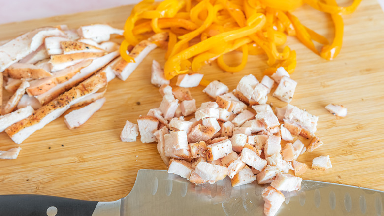 sliced chicken and pepper on cutting board