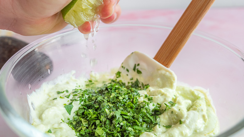 mixing avocado and sour cream