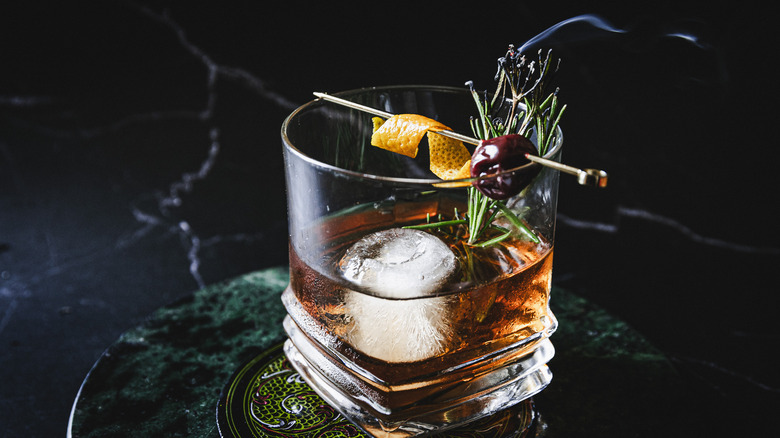 Cocktail with smoking rosemary branch