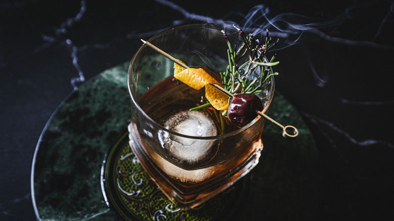 Cocktail with smoking rosemary branch