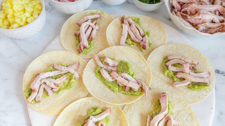 assembling smoked pork tacos