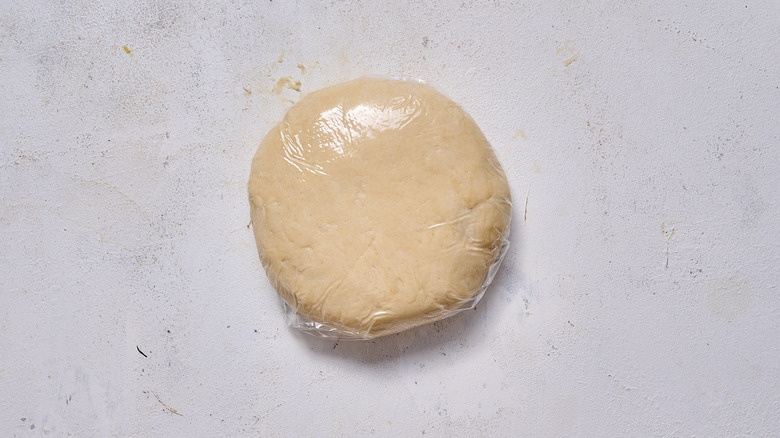 disc of dough wrapped in plastic