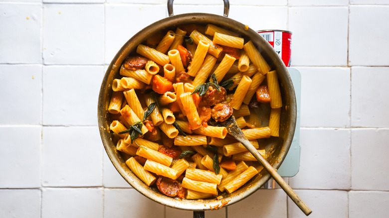 Cooked sausage and squash pasta in pan