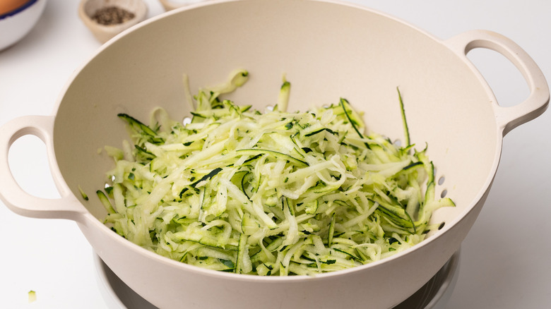 Grated zucchini in colander