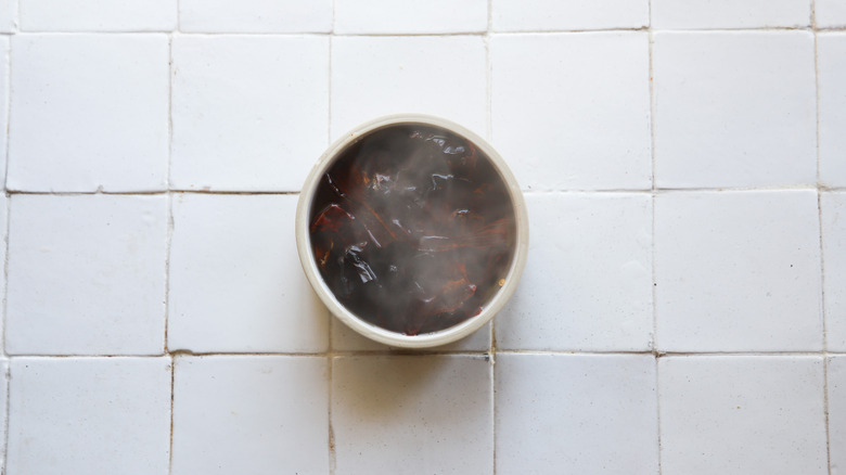 Bowl of steeping dried chiles 