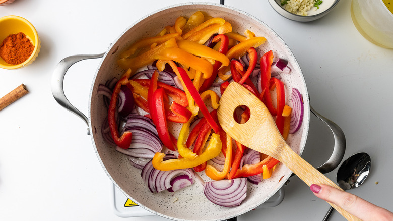 onions and peppers in pan 