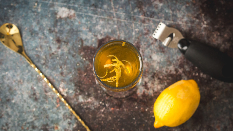 overhead view of drink with lemon curls