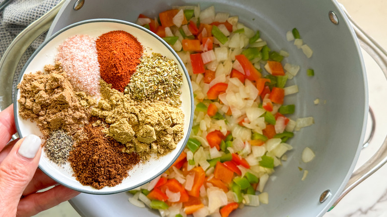 adding spices to pot