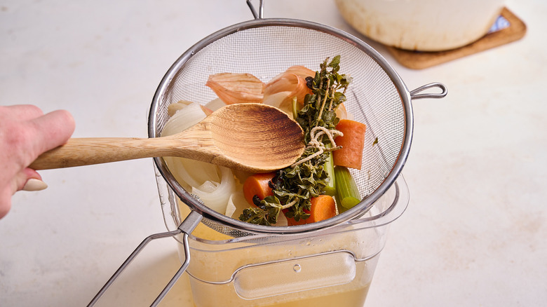 straining stock through colander