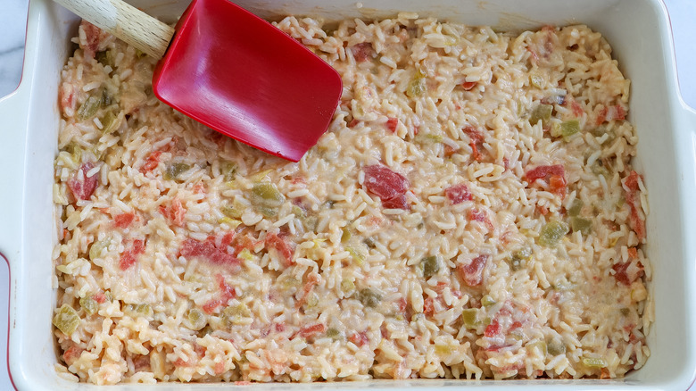 queso rice spread into a baking dish