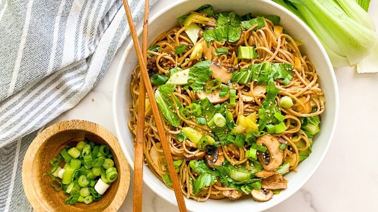 soba noodle and bok choy dish in white bowl