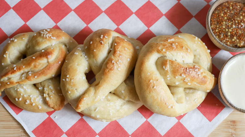 three soft pretzels with condiments